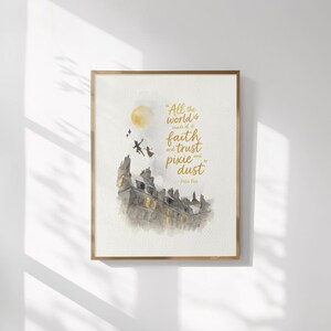 May include: A framed watercolor print featuring a quote from Peter Pan: "All the world is made of faith and trust and pixie dust." The artwork depicts a cityscape with silhouettes of Peter Pan and Tinkerbell flying near a full moon. The frame is a warm gold color.