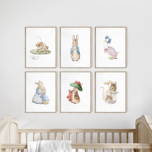 May include: A set of six framed watercolor prints featuring classic storybook characters including a rabbit fishing on a lily pad, a rabbit in a blue jacket, a duck in a bonnet, two rabbits embracing, a rabbit in a green hat, and a mouse with a broom.