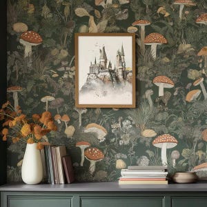 May include: A framed watercolour painting of a castle with a dark green background featuring a repeating pattern of mushrooms and foliage.