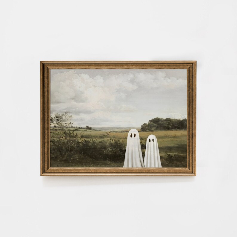 May include: A framed painting of a landscape with two white ghosts standing in a field. The painting is in a gold frame.