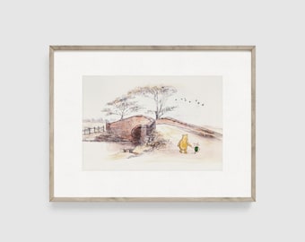 May include: Watercolor print of a bridge scene with a yellow bear and a pink piglet walking together. The bridge is made of brick, and the scene is set in a rural landscape with trees and birds in the sky. The print is framed.