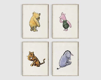 May include: Four framed prints featuring watercolor illustrations of Winnie the Pooh characters: Winnie the Pooh, Piglet, Tigger, and Eeyore. Each character is depicted in a unique pose, with soft colors and a whimsical style. The frames have a neutral, light-colored border.
