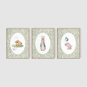 May include: Three framed prints with a green floral border. The prints feature illustrations of Peter Rabbit, a duck, and a frog. The prints are perfect for a nursery or child's room.