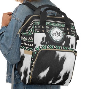 Personalized Black and white faux cowhide turquoise boho western style diaper bag backpack. Custom Monogrammed with your name or initials.