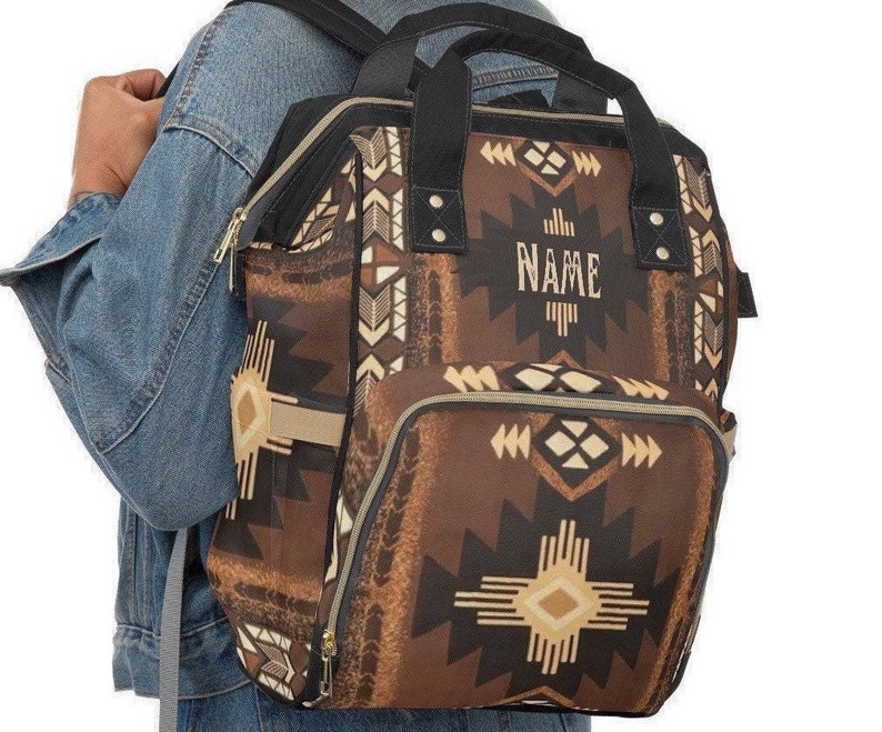 Personalized Brown and black southwestern tribal Indian boho western style diaper bag backpack. Custom monogrammed with your name or initials. Faux animal print backpack.