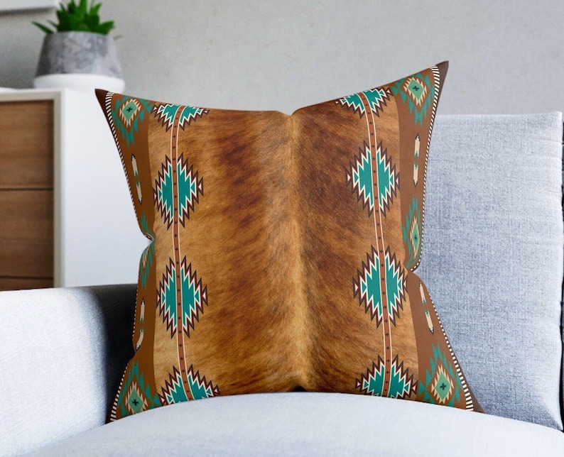 Western Brown faux cowhide print and turquoise tribal southwestern boho square throw pillow, the pillow cover is made of a faux suede fabric. Double sided print and comes in 3 sizes Includes pillow cover and pillow.