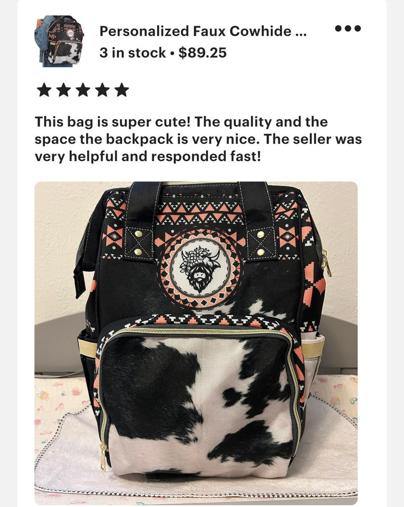 May include: Black and white cow print backpack with a pink and black geometric pattern. The backpack has a large main compartment and a smaller front pocket. The front pocket has a cow print design. The backpack has a black handle and a black zipper.
