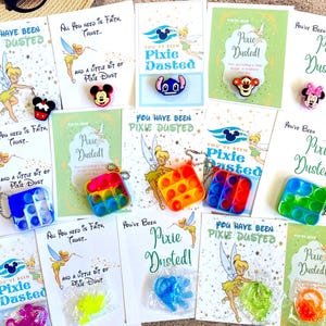 May include: Assortment of cards with the text "You Have Been Pixie Dusted!" and "All You Need Is Faith, Trust..." featuring Disney characters and small toys. Includes sunglasses and a straw hat.