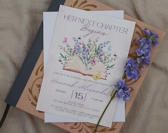 May include: A bridal shower invitation with the text "Her Next Chapter Begins." The invitation features an open book illustration with floral and butterfly accents. The date is August 15th, with the time 11:00 AM. The invitation is on a decorative background.