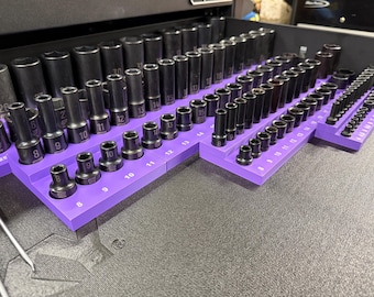 Peut inclure: Un organisateur violet avec une variété de clés à douilles noires. L'organisateur comporte des numéros de 6 à 25 imprimés dessus.