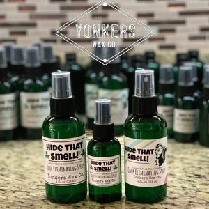 May include: Three green spray bottles with a skunk graphic and the text "Hide That Smell! Odor Eliminating Spray Yonkers Wax Co. 4 fl. oz (118 ml)"