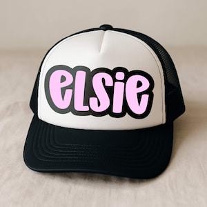 Trucker hat mockup with the name ‘Elsie’ set in Jelly Puff, a cute chunky handwritten font. Pink letters with a thick black offset outline in an all-caps mix-case style—perfect for personalized hats, Cricut/SVG heat transfers.