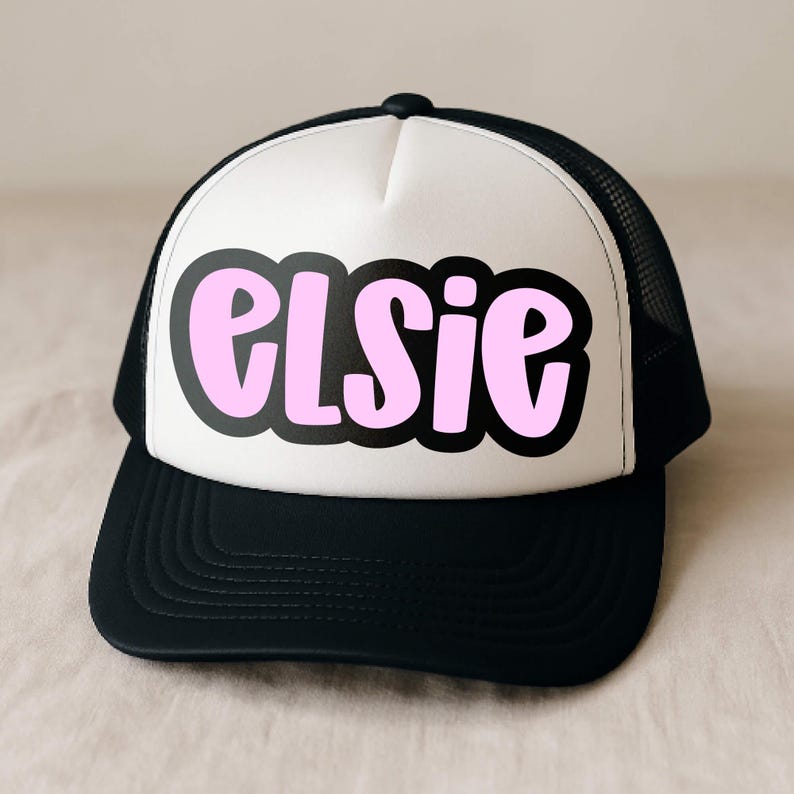 Trucker hat mockup with the name ‘Elsie’ set in Jelly Puff, a cute chunky handwritten font. Pink letters with a thick black offset outline in an all-caps mix-case style—perfect for personalized hats, Cricut/SVG heat transfers.