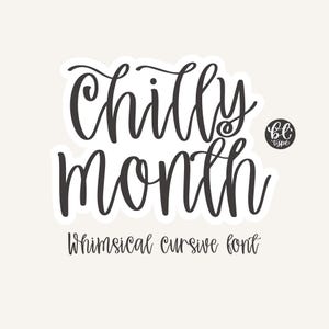 May include: A sticker with the words "Chilly Month" in a whimsical cursive font. The text is in dark gray, outlined in white, and set against a light beige background. The sticker also includes the text "Whimsical cursive font" and a small logo.