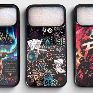 May include: Three phone cases with unique designs. One features a longhorn with text that reads "Stay Rooted". Another has a collage of images including playing cards and a Route 66 sign. The third case displays "Fox Racing" with a motocross rider.