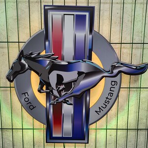 May include: A silver and blue Ford Mustang logo with a black running horse in the center. The logo has the words "Ford" and "Mustang" written on it.