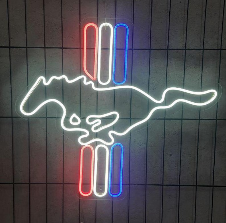 May include: White neon outline of a running horse with three vertical red, white, and blue neon bars.