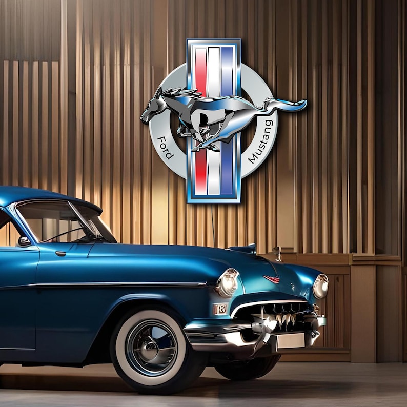 May include: A blue vintage car with chrome accents parked in front of a wood-paneled wall. The car has a Ford Mustang logo above it.