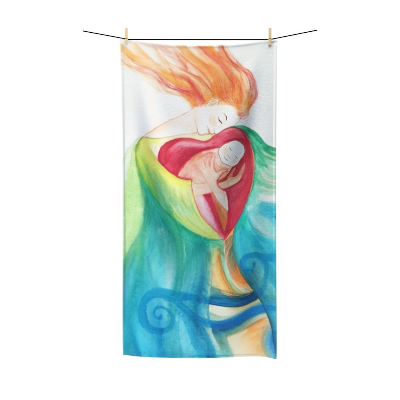 May include: A watercolor beach towel featuring a mother and child. The artwork depicts a woman with flowing red hair embracing a child within a heart-shaped form. The towel has a white background with green, blue, and red hues.