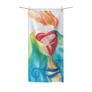 May include: A rectangular towel featuring a watercolor illustration of a mother and child. The artwork depicts a mother with flowing red hair embracing a child within a heart-shaped form. The color palette includes shades of green, blue, and orange.