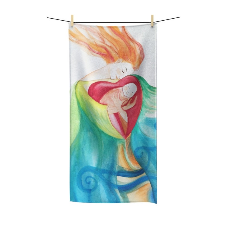 May include: A rectangular towel featuring a watercolor illustration of a mother and child. The artwork depicts a mother with flowing red hair embracing a child within a heart-shaped form. The color palette includes shades of green, blue, and orange.