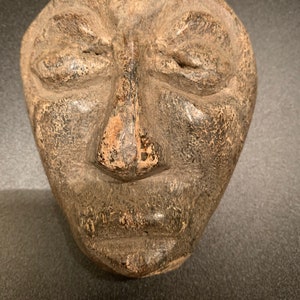 Authentic Chinese Mastodon Bone Carved into face in Indonesia