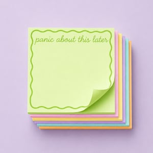 May include: A stack of colorful sticky notes with a light green top note. The top note has a wavy green border and the text "panic about this later". The other notes are pastel shades of pink, yellow, blue, and orange.