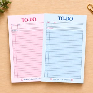 May include: Two rectangular to-do list notepads, one pink and one light blue. Each features the text TO-DO at the top, fields for date, name, and main goal, lined sections for tasks, and the text THANK YOU, PLEASE COME AGAIN at the bottom.
