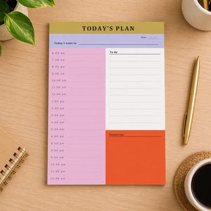May include: A colorful daily planner pad with the text "TODAY'S PLAN". The pad features sections for scheduling from 6:00 am to 12:00 am, a "To do" list, and a section for "Tomorrow". The planner has a gold, lavender, pink, and orange color scheme.