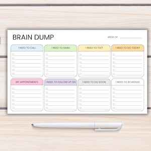 May include: A white Brain Dump notepad, sized 10" x 6", with sections for tasks like "I Need to Call" and "I Need to Email." Includes a pen. The notepad has a weekly planner format with checkboxes for each task.