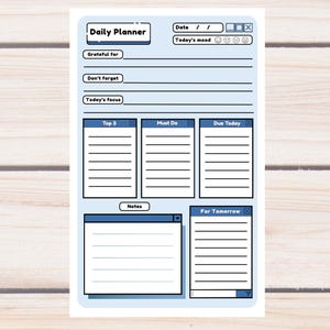 May include: A blue daily planner with a white border. The planner includes sections for the date, mood, gratitude, and notes. It also has sections for top 3 tasks, must-do items, and tasks due today and tomorrow. The word "Blue" is written at the bottom.