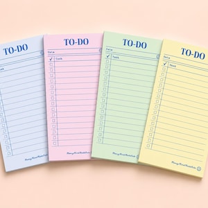 May include: Four rectangular to-do list notepads in light blue, pink, light green, and yellow. Each notepad features the text TO-DO at the top, a date line, a task column with checkboxes, and the text MerryMindMadeCute at the bottom.
