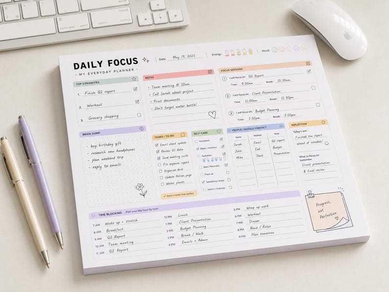 May include: A white daily focus planner notepad with pastel-colored sections for top priorities, notes, focus sessions, brain dump, tasks, self-care, contacts, reflection, and time blocking. The page includes printed text and handwritten entries.