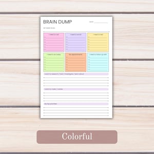 May include: A white paper planner page titled BRAIN DUMP with a date line and a main goal section. It features six colorful rectangular boxes for tasks, including pink, purple, yellow, green, orange, and blue, plus lined sections for notes.