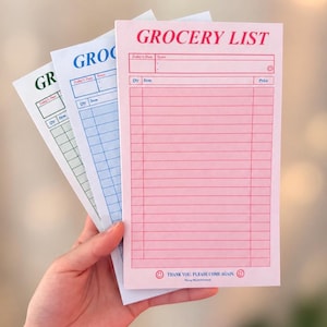 May include: Three rectangular grocery list notepads in pink, blue, and green. Each notepad features the text GROCERY LIST at the top, columns for Qty, Item, and Price, and the text THANK YOU. PLEASE COME AGAIN. with smiley face icons at the bottom.