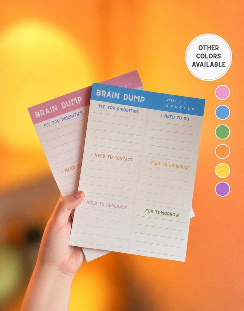 May include: Two rectangular paper planning sheets with the heading BRAIN DUMP. The sheets feature sections for MY TOP PRIORITIES, I NEED TO DO, I NEED TO CONTACT, I NEED TO SCHEDULE, I NEED TO PURCHASE, and FOR TOMORROW. A circular graphic indicates OTHER COLORS AVAILABLE.