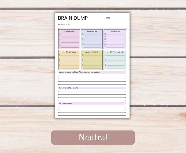 May include: A white paper planner page titled BRAIN DUMP with a date line and MY MAIN GOAL section. It features six colored boxes for tasks like I need to call and My appointments, plus lined sections for research, creation, and priorities.