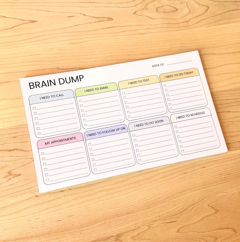 K&ouml;nnte beinhalten: Ein wei&szlig;er Brain Dump Notizblock mit Abschnitten f&uuml;r Aufgaben wie "I Need to Call", "I Need to Email" und "My Appointments". Der Notizblock hat ein einfaches Layout mit Kontrollk&auml;stchen f&uuml;r jede Aufgabe, konzipiert f&uuml;r die Wochenorganisation.