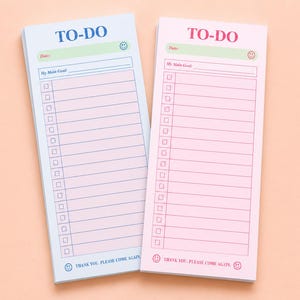 May include: Two rectangular to-do list notepads, one with a light blue background and one with a light pink background. Both feature the text TO-DO at the top, a date line, a My Main Goal line, a checklist with twelve rows, and the text THANK YOU. PLEASE COME AGAIN. at the bottom with smiley face icons.