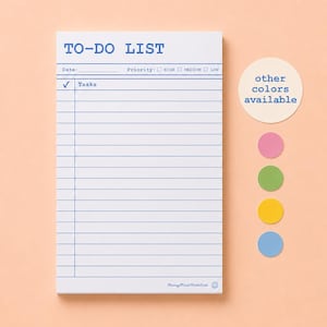 May include: A white rectangular to-do list notepad with blue printed lines, a date field, and priority checkboxes for high, medium, and low. The notepad features a checkmark column and task lines. A circular sticker shows other colours available.