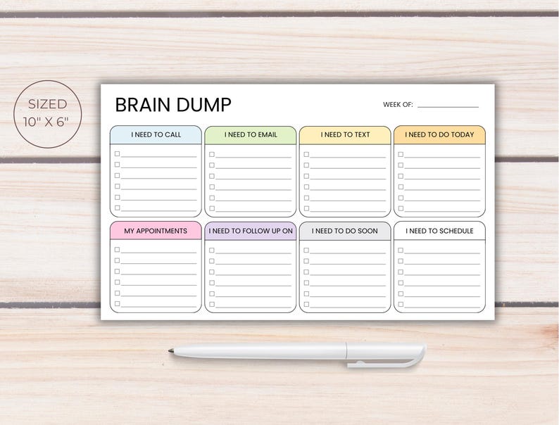 Wide brain dump planner notepad with organized task sections for calls, emails, texts, appointments, scheduling, and follow ups, shown on a light wood desk with a white pen and labeled 10 x 6 inches.