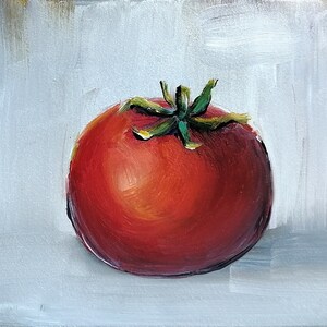 May include: A single, ripe red tomato with a green stem and leaves, painted in oil on a white canvas.
