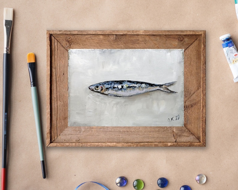 May include: A framed painting of a single silver fish on a white background. The painting is signed "O.K. 22" in the bottom right corner.
