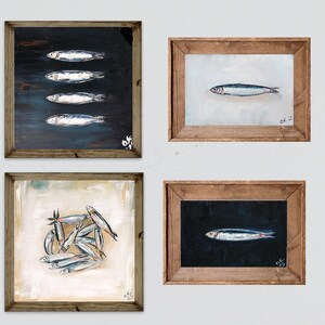 May include: Four framed fish paintings. The top left painting has four fish on a dark background. The top right painting has one fish on a white background. The bottom left painting has a group of fish on a white background. The bottom right painting has one fish on a dark background.