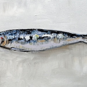 May include: A painting of a silver and blue fish on a white background. The fish has a dark eye and a red spot on its side. The artist's signature, "O.K. 22", is in the bottom right corner.