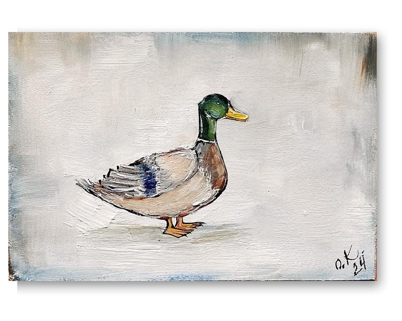 May include: A painting of a mallard duck with a green head and yellow beak on a white background. The duck is facing to the right and has its wings folded. The artist's signature is in the bottom right corner of the painting . Mallard duck painting original miniature art Vintage duck oil painting farmhouse kitchen wall art country decor duck hunting gift 4x6