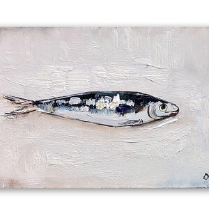 May include: Oil painting of a fish on a white background. The fish is painted in shades of black, white, and blue, with visible brushstrokes. The artwork is signed in the bottom right corner.