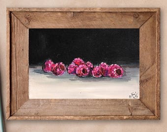 May include: A framed painting of a still life with a cluster of pink raspberries on a white surface against a black background.