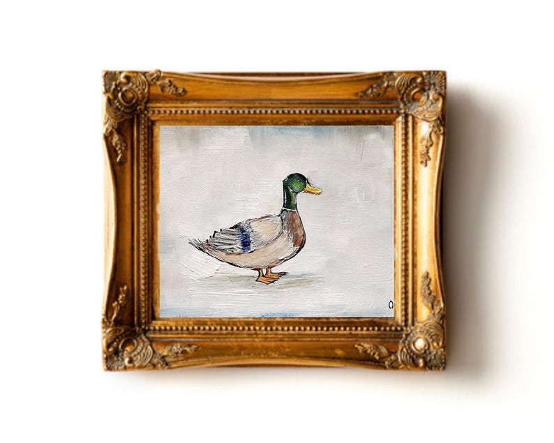 May include: A painting of a mallard duck in a gold frame. The duck is facing to the right and has a green head and a yellow beak. The duck is painted on a white background. Mallard duck painting original miniature art Vintage duck oil painting farmhouse kitchen wall art country decor duck hunting gift 4x6