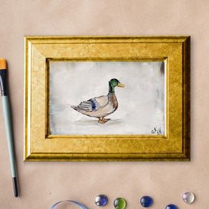 May include: A framed painting of a mallard duck with green head and brown feathers, set against a white background. Mallard duck painting original miniature art Vintage duck oil painting farmhouse kitchen wall art country decor duck hunting gift 4x6